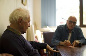 Two men talking together at a table