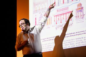 Artist pointing at a projection screen