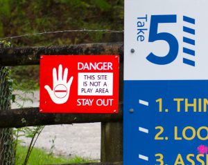 A sign with an image of hand signalling 'danger'