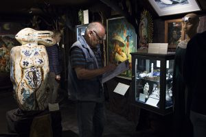 A man drawing in front of a museum display case