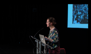 a women speaking at a lecturn